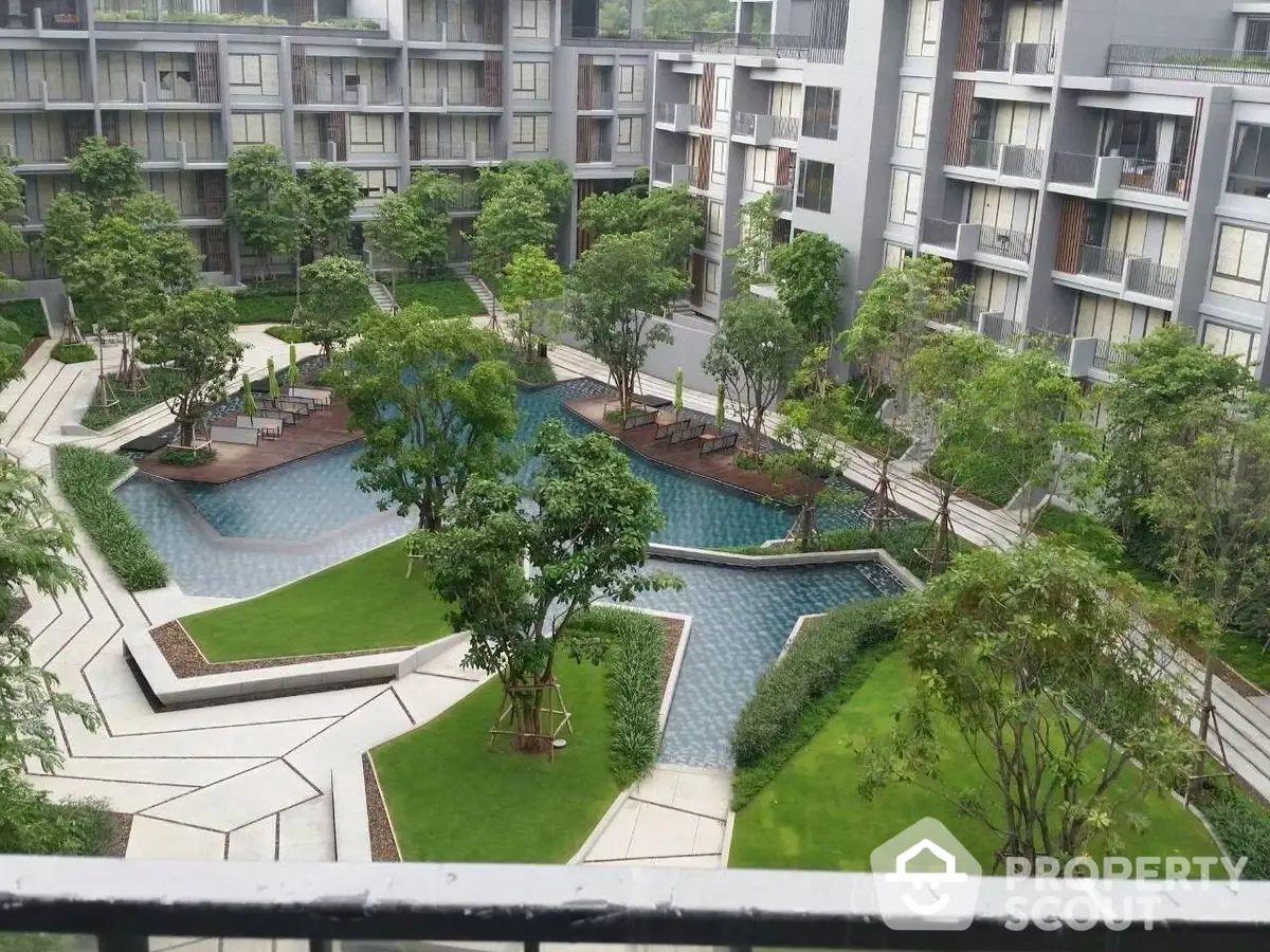 Lush communal garden with serene pool in a modern residential complex, offering a tranquil oasis amidst urban living, perfect for relaxation.