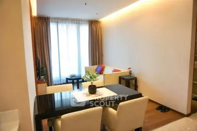 Elegant living room with modern dining area and large window, perfect for urban living.