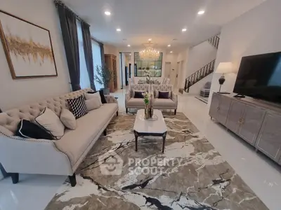 Luxurious living room with elegant decor, plush sofas, and a stunning chandelier, perfect for sophisticated gatherings.