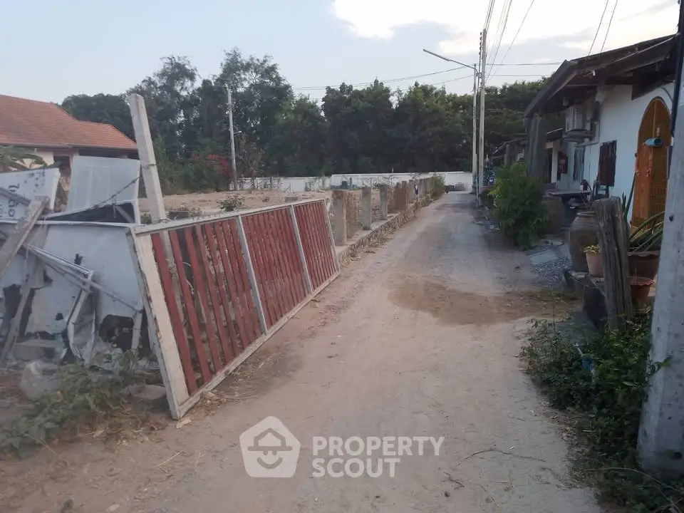 Charming rural property with rustic pathway and lush greenery, ideal for serene living or investment.