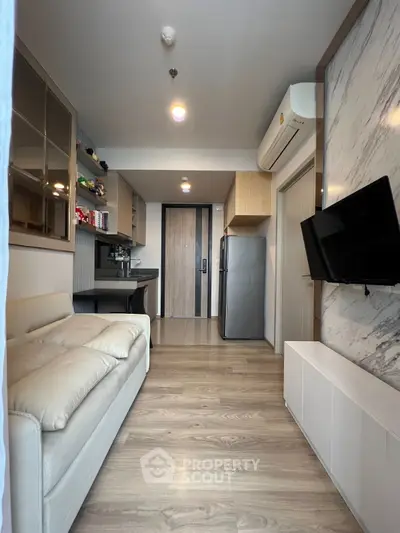 Modern compact living room with sleek design and integrated kitchen area