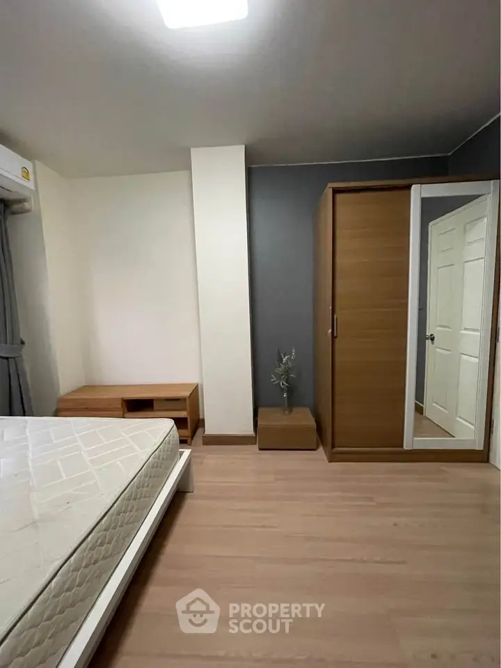 Modern bedroom with wooden wardrobe and minimalist decor