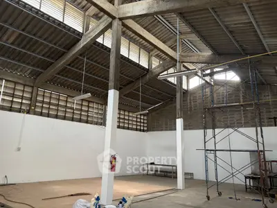 Spacious industrial warehouse interior with high ceilings and natural light