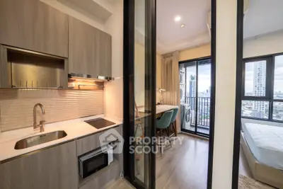 Modern apartment with compact kitchen and city view balcony