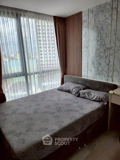 Modern bedroom with large window and stylish decor in urban apartment