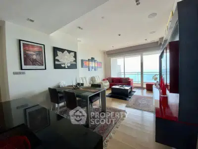 Luxurious living room with modern decor and stunning sea view balcony.