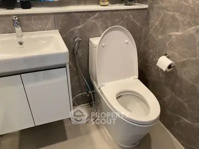 Modern bathroom with sleek fixtures and elegant marble tiles.