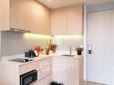 Modern kitchen with sleek cabinetry and built-in appliances in a stylish apartment.
