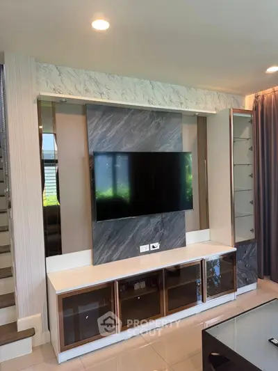 Modern living room with sleek TV unit and elegant decor