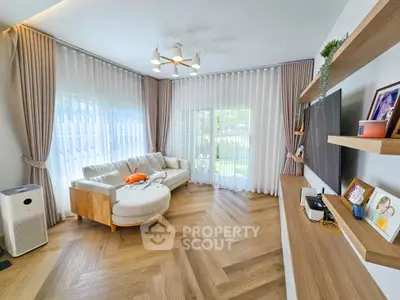 Spacious living room with modern decor and large windows for natural light