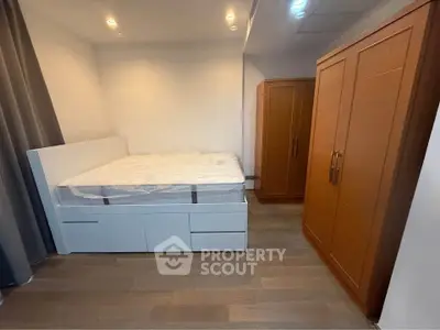 Spacious bedroom with modern bed and ample wardrobe storage