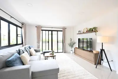 Spacious modern living room with large windows and stylish decor