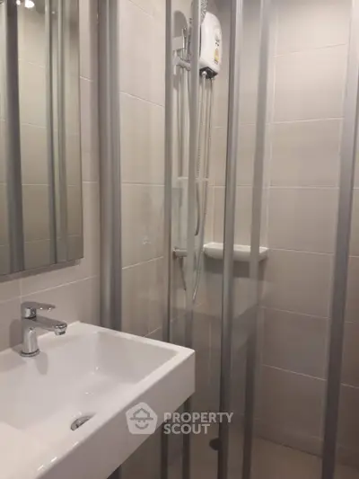 Compact bathroom with modern shower and sink in sleek design