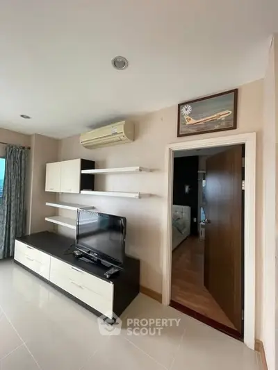 Modern living room with sleek TV unit and open shelving