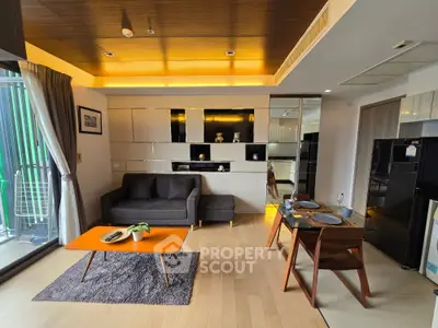 Modern living room with stylish furniture and open layout, featuring a cozy sofa and elegant dining area.