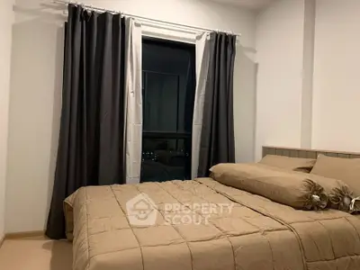 Cozy bedroom with elegant curtains and comfortable bedding in modern apartment.