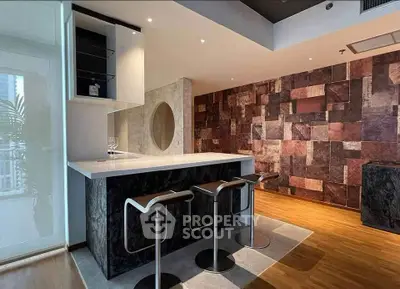 Modern kitchen with sleek bar stools and stylish wall design