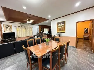 Spacious living and dining area with modern decor and ample lighting.