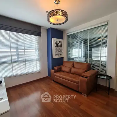 Modern living room with stylish decor and large windows offering ample natural light.