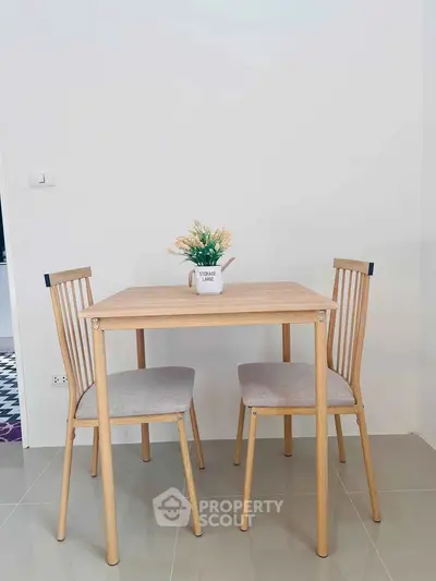 Charming dining nook with wooden table and chairs, perfect for cozy meals in a modern home.