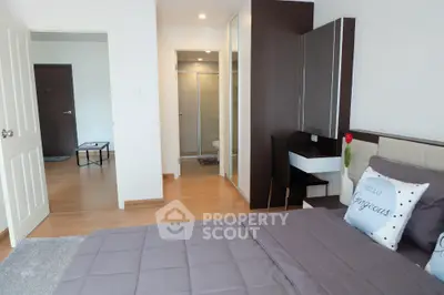 Modern bedroom with stylish decor and ensuite bathroom in a contemporary apartment.