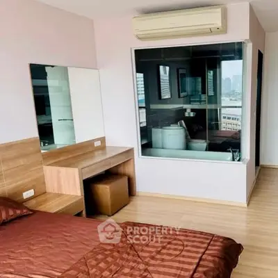 Modern bedroom with city view and unique glass partition bathroom.