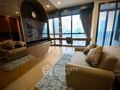 Modern living room with large windows and city view, featuring stylish decor and comfortable seating.