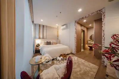 Luxurious bedroom with elegant decor and cozy ambiance, featuring a plush bed and stylish furnishings.