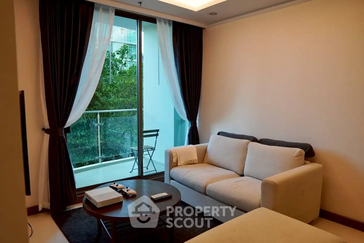 Modern living room with cozy sofa and balcony view in urban apartment
