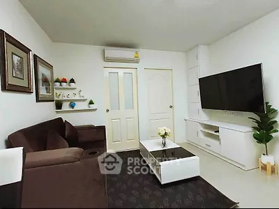 Modern living room with sleek furniture and large TV, perfect for relaxation and entertainment.