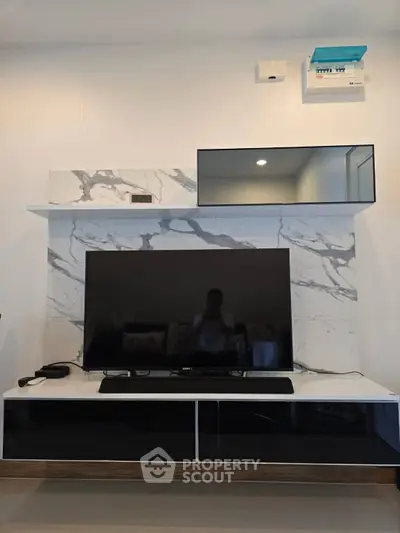 Modern living room with sleek TV setup and marble accent wall