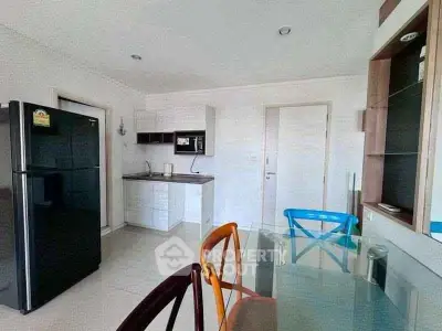 Modern kitchen with sleek appliances and dining area in a stylish apartment.