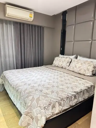 Modern bedroom with stylish decor and air conditioning in a cozy apartment.