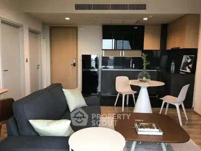 Modern open-layout living room with sleek kitchen and stylish furniture