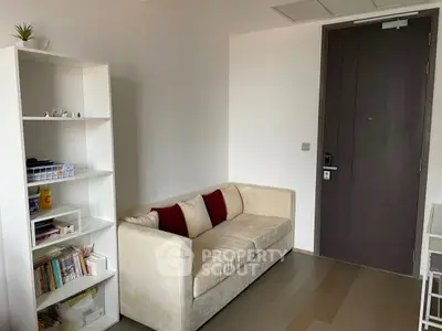 Cozy living room with modern sofa and bookshelf, perfect for relaxation and reading.