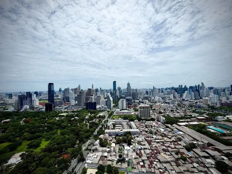 Stunning aerial view of a vibrant city skyline with lush green parks and modern skyscrapers.