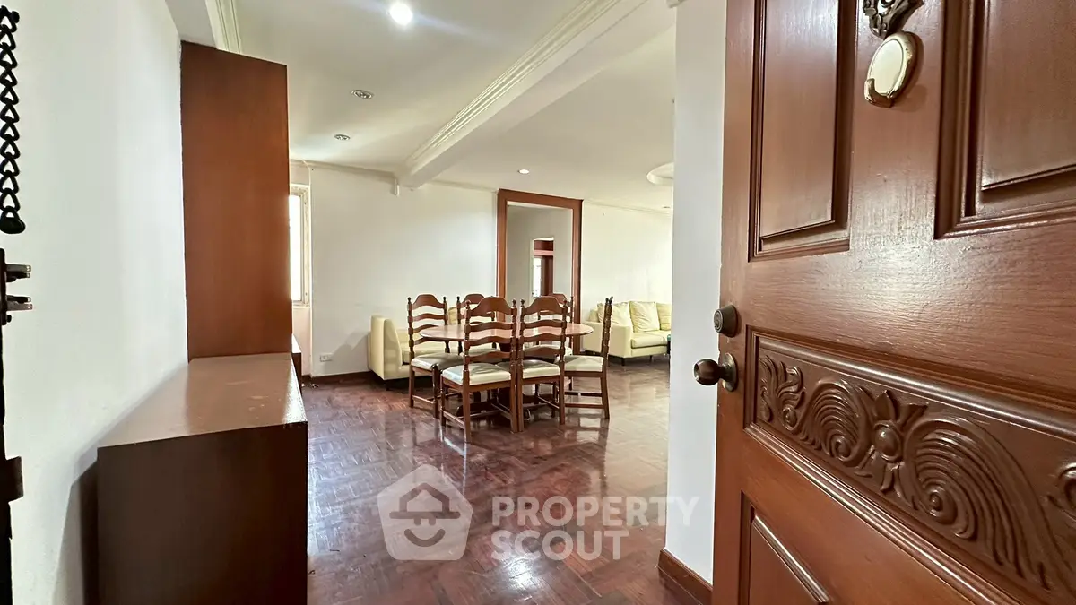 Spacious living room with elegant wooden flooring and classic furniture