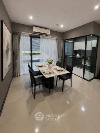 Modern dining area with elegant table setting and open kitchen layout in a stylish apartment.