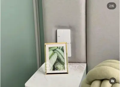 Stylish bedroom nightstand with modern decor and elegant wall paneling.