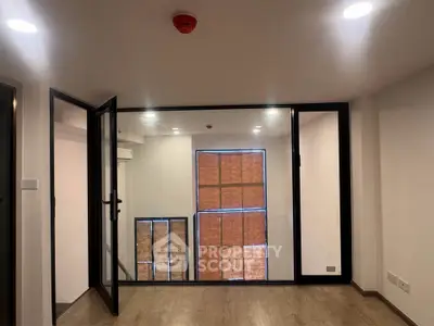 Modern interior with large glass doors and wooden flooring