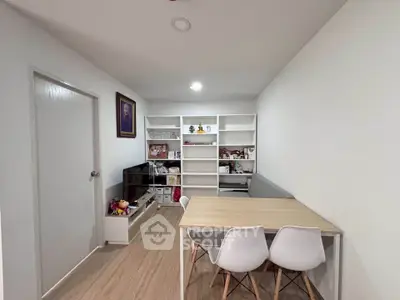 Modern study room with sleek wooden flooring and minimalist furniture, perfect for productivity and style.