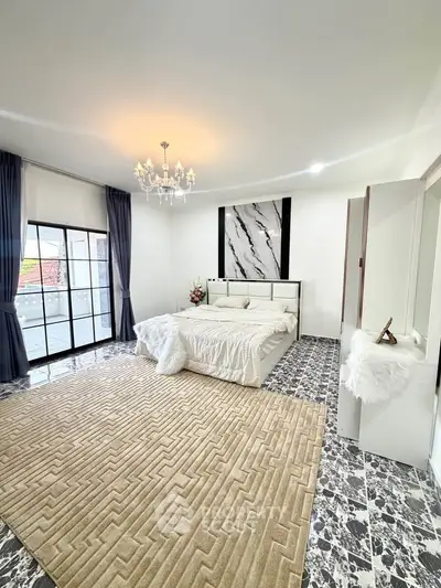 Luxurious bedroom with elegant decor and large windows offering natural light
