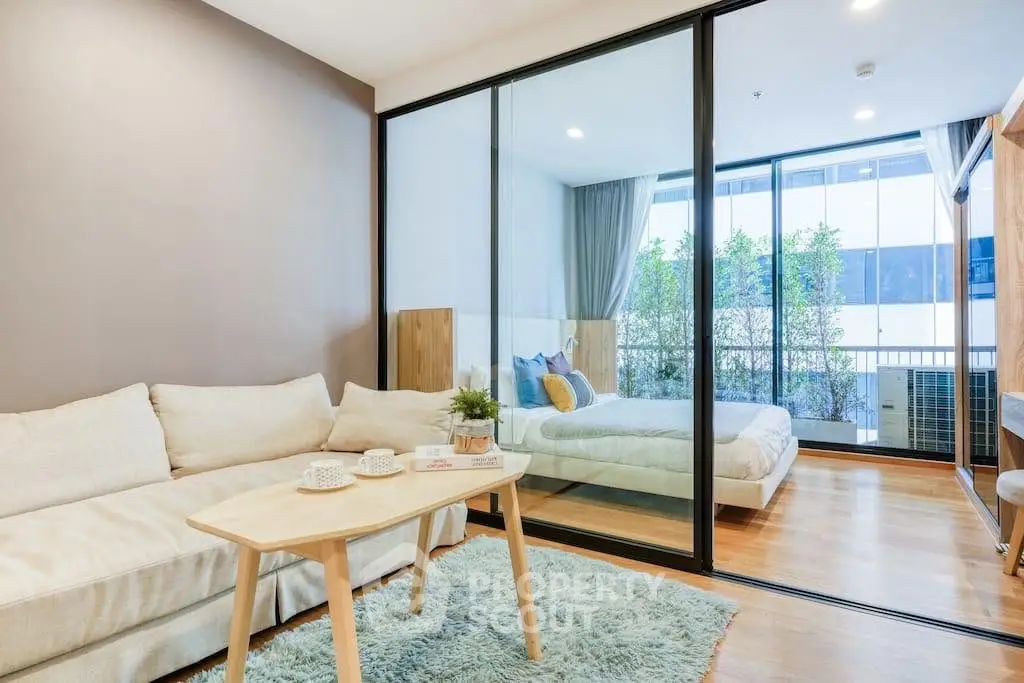 Modern studio apartment with glass partition and cozy decor