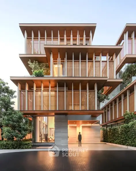 Stunning modern architectural building with unique wooden facade and lush greenery.