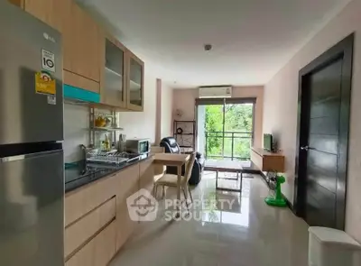 Modern open-layout kitchen and living area with balcony view in stylish apartment.