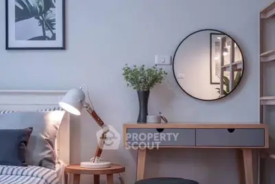 Modern living room with stylish decor and round mirror