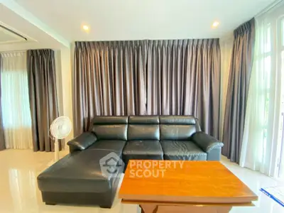 Spacious living room with elegant leather sofa and natural light