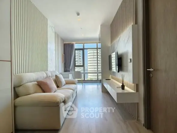 Modern living room with stylish decor and large windows offering a stunning view.