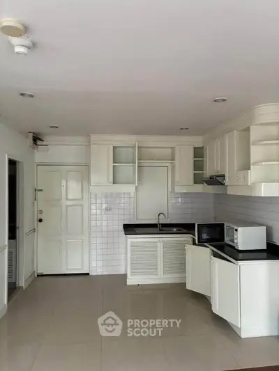 Spacious kitchen with modern appliances and sleek cabinetry in a stylish apartment.