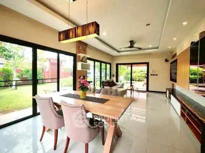Spacious living room with garden view and modern dining area